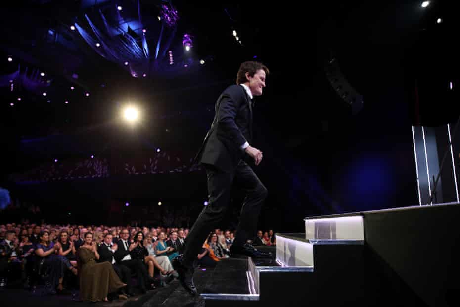 Damon Herriman runs up to the podium to accept an Aacta for his role in Judy & Punch