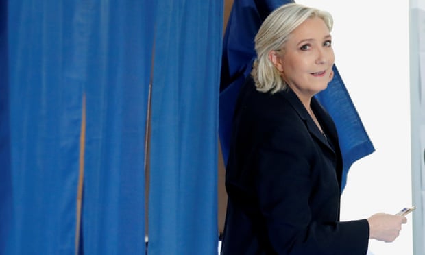 Marine Le Pen leaves a polling booth after voting.