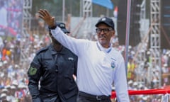 Rwanda's president Paul Kagame waves at crowds