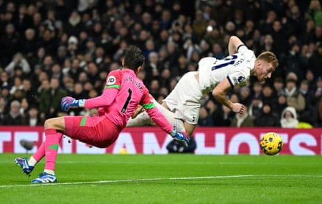 Lukasz Fabianski bundles over Dejan Kulusevski in the opening seconds at Tottenham.