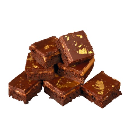Stack of brownies with gold leaf on them