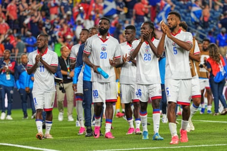 Haiti players applaud fans.