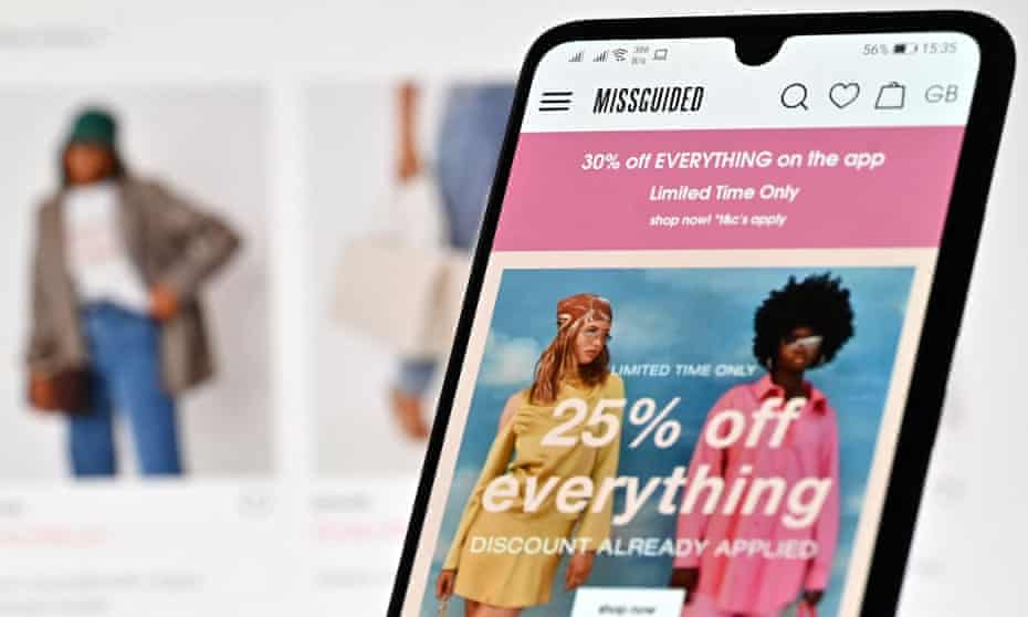 An illustration with a laptop and mobile phone shows the website of online fashion retailer Missguided on August 12, 2021.