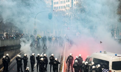 Protesters face riot police as they take part in a demonstration against Covid-19 measures in Brussels.