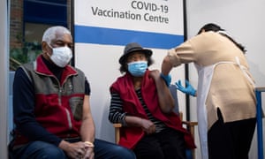 Winston (L) and Lorna Lucas receiving their vaccinations at Guy’s Hospital in London.