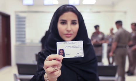 Esraa Albuti shows off her new driving licence at the traffic department in Riyadh on Monday