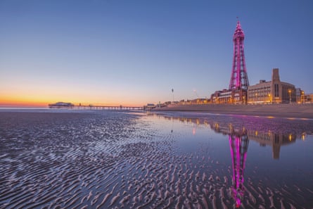 Iron tower at sunset over a rippled sandy beach
