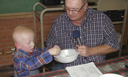 Eric Kuhlman, three, helps master of ceremonies Stan Miller draw names for the annual Norcatur Christmas drawing.