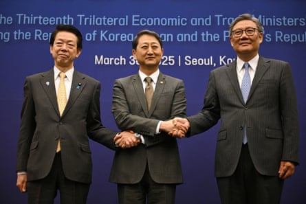 The three men shaking hands