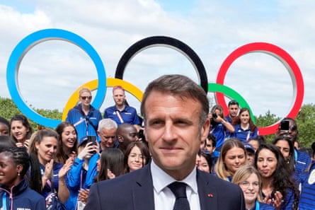 President Emmanuel Macron meets with French athletes as he visits the Olympic village.