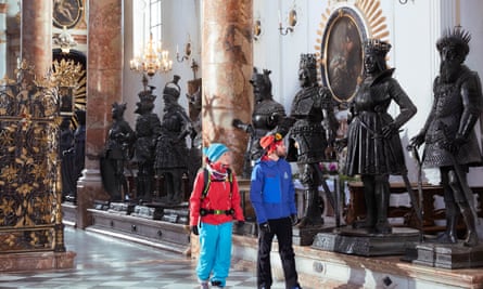 Two tourists in Innsbruck’s Hofkirche, with statues surrounding the tomb of Emperor Maximillian