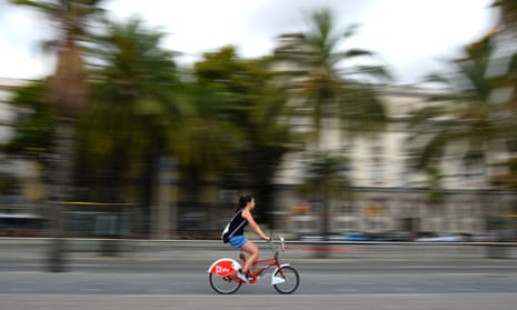 A woman rides on a cycle from Barcelona’s Bicing service.