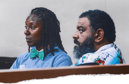 Two Black people sit in court