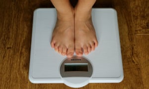 A child standing on some scales