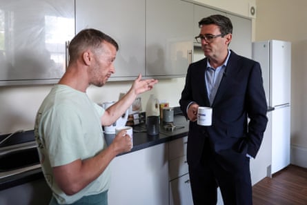 Andy Burnham speaks with a service user in a kitchen