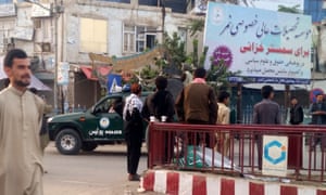 Alleged Taliban militants patrol on an Afghan police vehicle after they reportedly took control of most of Kunduz city, Afghanistan