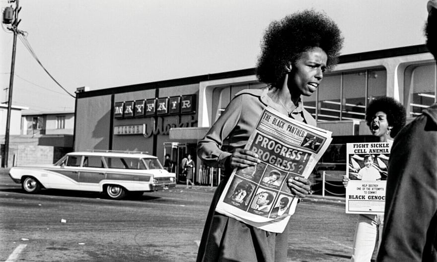 Gloria Abernethy sells the Black Panther newspaper.  Tamara Lacey holds a poster about sickle cell disease during the Mayfair supermarket boycott in Oakland, California, in 1971.