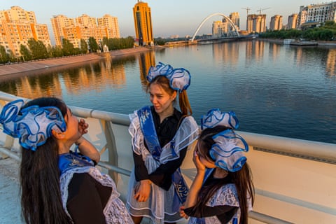 Schoolgirls in Nur-Sultan on the the last day of term, wearing traditional Soviet school dress, often worn by their mothers.
