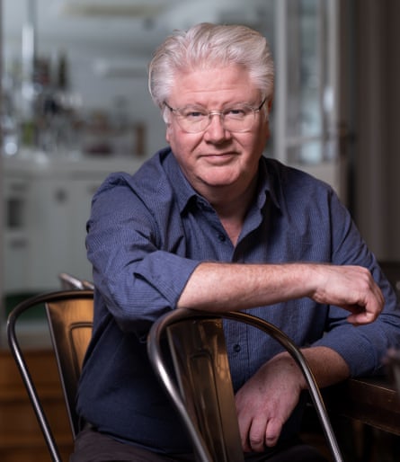 Paul Flynn sits on a chair, leaning against another, in the Tannery Cookery School