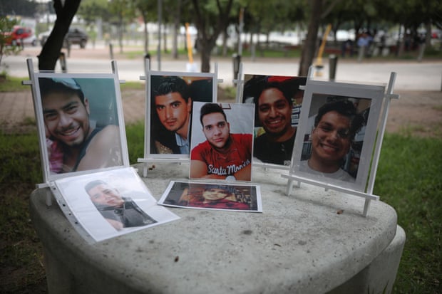 Portraits of missing people are displayed over a table outside the Forensic Medical Service in Guadalajara, Jalisco.