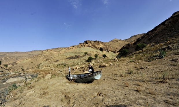 Yemeni men inspect an abandoned boat at a drought-affected dam on the outskirts of Sana’a.