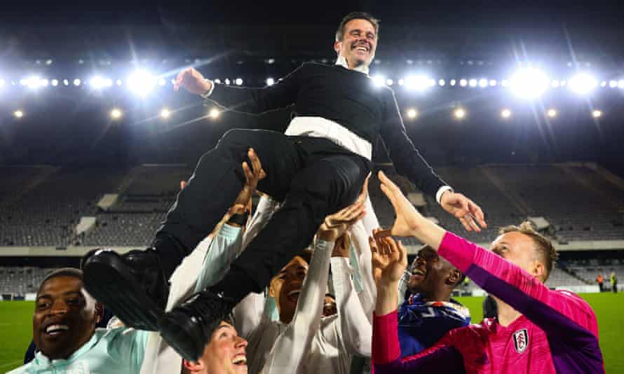 Marco Silva is hoisted in the air by his players after guiding Fulham to automatic promotion.