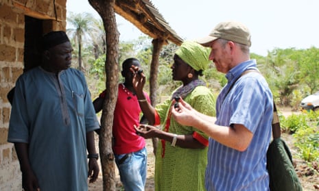 WasteAidUK project manager Mike Webster and Women’s Initiative – The Gambia leader Isatou Ceesay demonstrate organic fuel briquettes to a community.