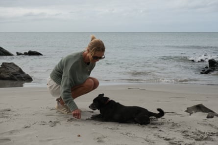 A woman with a dog on a beach