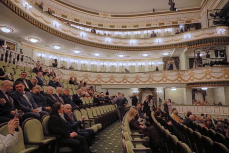 Spectators sit at auditorium of the Mariupol Drama Theatre in the Russian-controlled Donetsk region of eastern Ukraine.