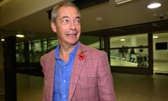 Nigel Farage wearing a pink jacket looks away from the camera