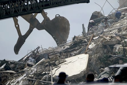 Search and rescue workers go through rubble hoping to detect any sounds coming from survivors.