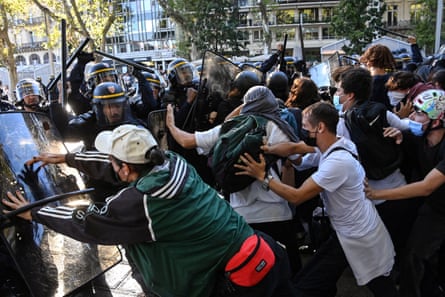 Riot police with shields and batons clash with student protesters during a demonstration in Montpellier