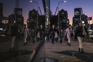 People walk home at dusk in the Aoyama area of Tokyo earlier this week.