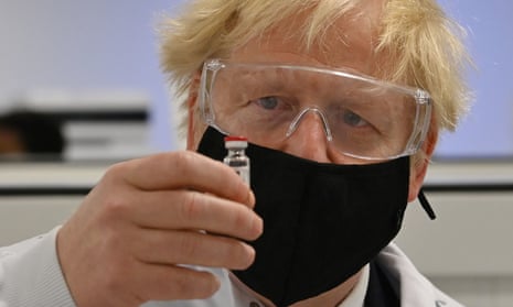 Boris Johnson holding the Oxford/AstraZeneca vaccine
