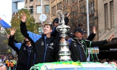 Members of Emirates Team New Zealand parade the America’s Cup yachting trophy through the streets of Auckland.