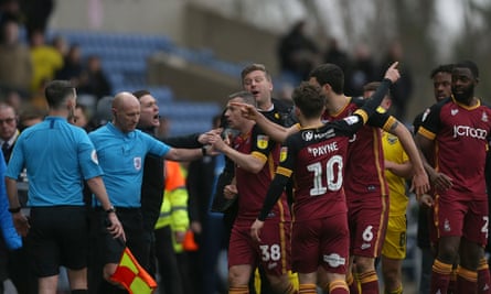 Bradford City players confront the referee amid late drama at Oxford.