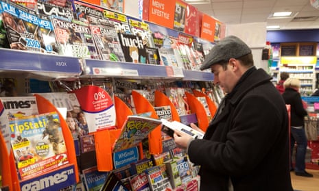 A man reads a magazine in WH Smith