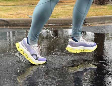 a person running in the rain with Cloudmonster Hyper running shoes