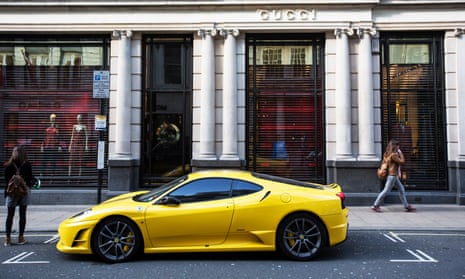 A yellow Ferrari parked outside Gucci on Old Bond Street in London