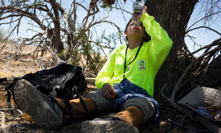 Taking a break: volunteer Juan Carlos Genis, 14, rehydrates in the Cabeza Prieta wilderness, after hiking six miles in temperatures over 95F.