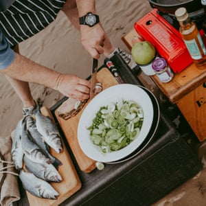 Chef Charlie Hodson cooking lunch on the sandbank.