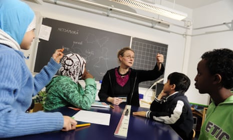a female teacher in a class with pupils at Meri-Rastila primary school in Helsinki