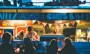 Customers buying food from a burger van at The Great Estate Festival, Cornwall