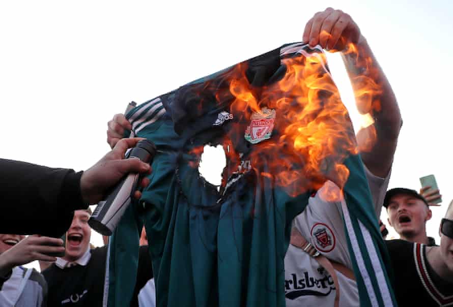 Football fans burn a replica Liverpool shirt outside Elland Road before their match with Leeds in protest at the ESL.