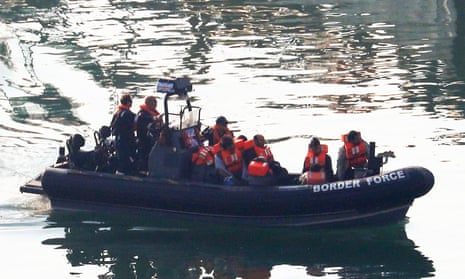 A group of men are brought to shore by Border Force officers at the Port of Dover.