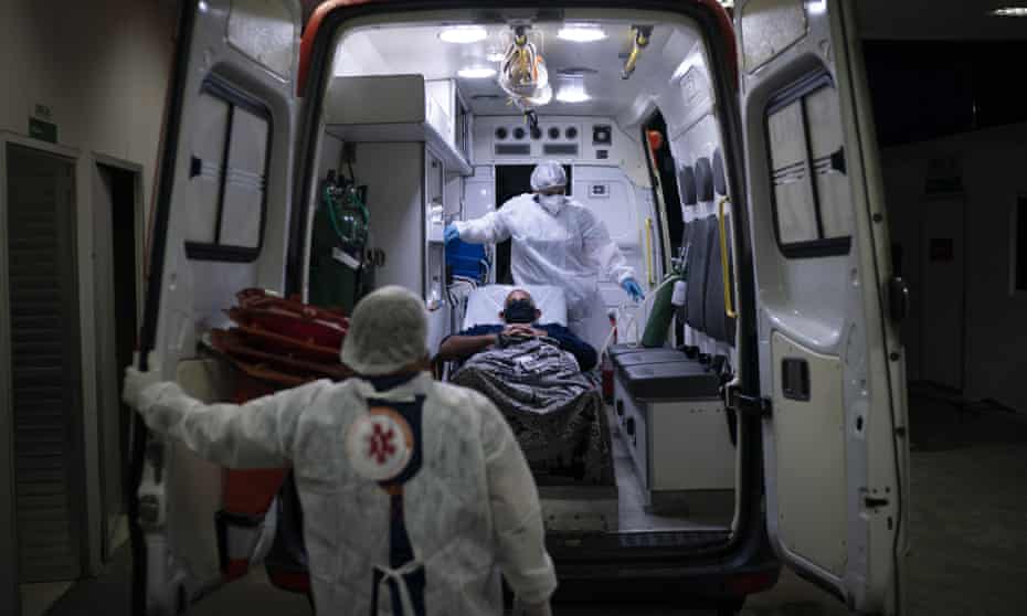 A Covid-19 patient is put in an ambulance