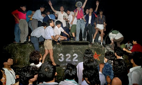 Protestors stand on a tank in the early hours of 4 June 1989, when China brutally cracked down on pro-democracy protestors in Tiananmen Square.