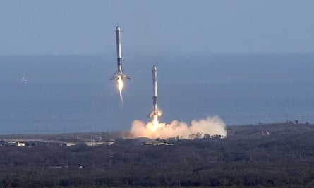 Two booster rockets from the Falcon 9 SpaceX heavy, return for a landing