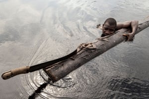Ikuejamoye takes a rest from moving logs from the forest floor to the river