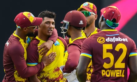 Gudakesh Motie is embraced his his West Indies teammates after dismissing England’s in-form Phil Salt